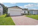 One-story house with a brick driveway and landscaped lawn at 5186 Minneola Ln, Saint Cloud, FL 34772