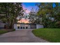 Mid-century modern home with landscaped yard and driveway at 2916 Oxford St, Orlando, FL 32803