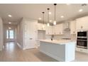 Bright, modern kitchen with white cabinets, quartz countertops and stainless steel appliances at 3255 Roseville Dr, Apopka, FL 32712