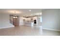 Open-concept living space featuring tile floors and a view of the modern kitchen at 3255 Roseville Dr, Apopka, FL 32712