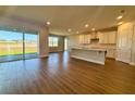 Bright, open-concept living space with wood-look tile floors and sliding glass doors to the backyard at 3279 Roseville Dr, Apopka, FL 32712