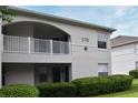 Exterior view of building featuring balcony, manicured shrubs, and well-maintained lawns at 570 Cranes Way # 248, Altamonte Springs, FL 32701