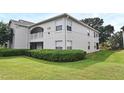 Attractive condo building with manicured landscaping and a charming second-floor balcony at 570 Cranes Way # 248, Altamonte Springs, FL 32701