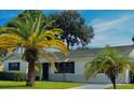 Newly painted white single story house with dark navy blue shutters and front door at 858 Darwin Dr, Altamonte Springs, FL 32701