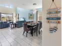 Open-concept living space with high ceilings, tile flooring, and elegant decor at 8938 Cabot Cliffs Dr, Davenport, FL 33896