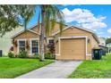 Charming single-story home with a well-manicured lawn and an attached two-car garage at 188 Ridgemont Ct, Davenport, FL 33896