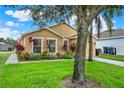 Landscaped front yard featuring lush lawn and colorful flowerbeds at 188 Ridgemont Ct, Davenport, FL 33896
