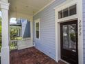 Inviting front porch with a swing and a decorative glass front door entrance at 2072 Hartz Aly, Orlando, FL 32814