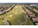 Expansive golf course surrounded by houses and mature trees at 8930 Azalea Sands Ln, Davenport, FL 33896
