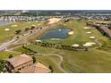 Scenic aerial view of a golf course with a water feature at 8930 Azalea Sands Ln, Davenport, FL 33896