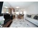 Bright living room with neutral decor and a dining area, perfect for relaxing or entertaining at 3276 Candle Ridge Ct # 202, Orlando, FL 32822