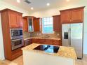 Well-equipped kitchen featuring stainless steel appliances and granite counters at 7465 Excitement Dr, Reunion, FL 34747