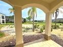 Beautiful golf course view from covered patio with arched entry at 7465 Excitement Dr, Reunion, FL 34747
