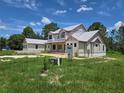 New construction home featuring a modern elevation, large windows, and a covered front porch at 405 Long And Winding Rd, Howey In The Hills, FL 34737