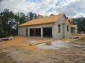 New construction showing the home's garage area with block construction and a roof at 405 Long And Winding Rd, Howey In The Hills, FL 34737