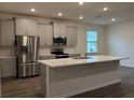 Modern kitchen with stainless steel appliances and island at 300 Barebow Ln, Ormond Beach, FL 32174