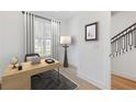 Bright office space features a modern desk, floor lamp, and large window with natural light at 2110 Whitney Marsh Aly, Orlando, FL 32804
