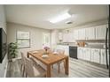 Bright kitchen features white cabinets, modern appliances, granite countertops, and light gray wood-look floors at 507 Francis Blvd, Lakeland, FL 33801