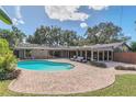 Beautiful backyard featuring a large swimming pool with brick paver patio, perfect for outdoor living and entertaining at 51 Oakleigh Ln, Maitland, FL 32751