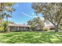 Charming single-story home with a well-manicured lawn, mature trees and lush landscaping offering great curb appeal at 51 Oakleigh Ln, Maitland, FL 32751
