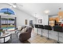 Open living space combines a modern kitchen with a cozy living area near a pool view at 503 Balmoral Dr, Davenport, FL 33896