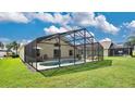 Enclosed pool area with lounge chairs and backyard access at 503 Balmoral Dr, Davenport, FL 33896
