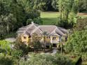 Expansive estate home with a tile roof, lush landscaping, and an over-sized driveway at 3499 Rockcliff Pl, Longwood, FL 32779