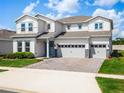Charming two-story home featuring a three-car garage, neat landscaping and a manicured front lawn at 3198 Sailing Pier Ave, Winter Garden, FL 34787