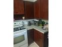 Cozy kitchen featuring wood cabinets and modern appliances at 108 5Th Jpv St, Winter Haven, FL 33880