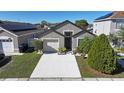 One-story house with driveway, landscaping, and neighboring homes visible at 13136 S Ashington Pointe Dr, Orlando, FL 32824