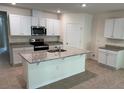 A spacious kitchen featuring granite countertops, stainless steel appliances, and ample white cabinetry at 1552 Lakeside Dr, Deland, FL 32720