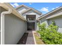 Brick pathway leads to a black front door, adding curb appeal at 1451 Twin Rivers Blvd, Oviedo, FL 32766