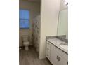 Clean bathroom with shower/tub combo, vanity with granite countertop, and tile flooring at 16613 Point Rock Dr, Winter Garden, FL 34787