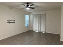 Bright living room with tile floors, ceiling fan, and sliding glass doors at 16613 Point Rock Dr, Winter Garden, FL 34787