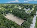 Aerial view of expansive equestrian property with riding arena, stables, and lush landscape at 2075 Genova Dr, Oviedo, FL 32765