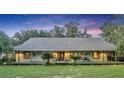 House exterior at dusk showcasing a large front porch at 2075 Genova Dr, Oviedo, FL 32765