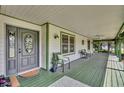 Inviting front porch with seating and ceiling fan at 2075 Genova Dr, Oviedo, FL 32765