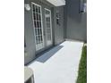 Outdoor patio with door access and green foliage nearby at 14460 Clarkson Dr, Orlando, FL 32828