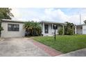 Charming single-story home features a well-maintained lawn, brick walkway, and lovely curb appeal at 2819 Pembrook Dr, Orlando, FL 32810