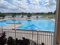 Refreshing community pool with lake view and lounge chairs at 6147 Sunnyvale Dr, Orlando, FL 32822