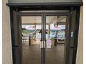 Ventura Country Club restaurant entrance doors reflecting the interior and exterior at 6147 Sunnyvale Dr, Orlando, FL 32822