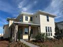 Two-story house with light beige siding, stone accents, and a landscaped yard at 10257 Medawar St, Orlando, FL 32827