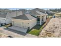 Modern two-story home with a two-car garage, manicured landscaping, and a modern design at 10257 Medawar St, Orlando, FL 32827
