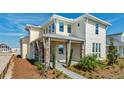 Stylish two-story home with a stone-accented porch, showcasing a blend of modern architecture and well-maintained landscaping at 10257 Medawar St, Orlando, FL 32827