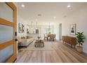 Bright open-concept living area with hardwood floors flows into dining area and kitchen for easy entertaining at 4058 Sw 167Th St, Ocala, FL 34473