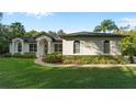 White house with a gray roof, landscaping, and walkway at 17577 Davenport Rd, Winter Garden, FL 34787