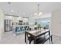 Open kitchen and dining area with stainless steel appliances, an island, and views into the cozy living area at 4271 Tigris Dr, Apopka, FL 32712