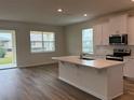 Open concept kitchen and living area with hardwood floors and an island at 334 Rover Rd, Ormond Beach, FL 32174