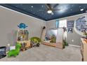 Cozy bedroom with painted ceiling, large window, and playful decor, creating a fun and inviting atmosphere at 1069 River Otter Way, Deland, FL 32720
