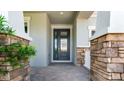 Close-up of the front door, showcasing brick accents and a covered entryway at 5249 Stone Ridge Pl, St Cloud, FL 34771